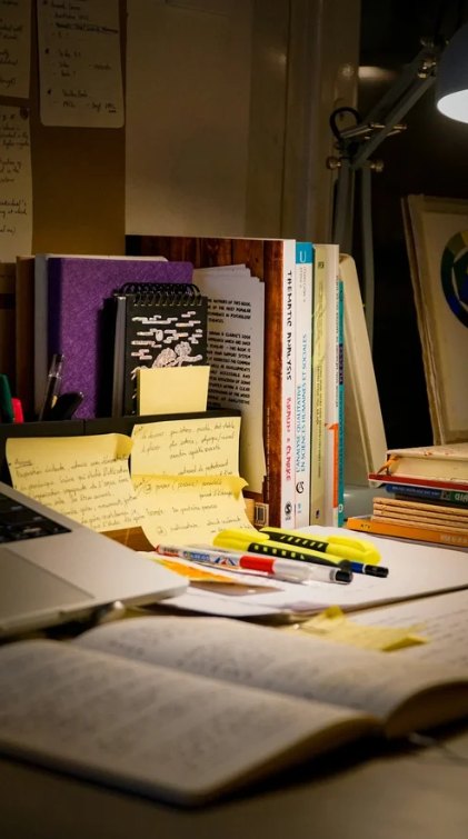 A student working at a desk with a marked page in front of them