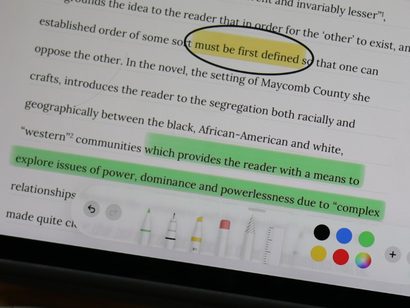An essay on To Kill a Mockingbird being marked on an iPad, with a phrase circled and lines highlighted