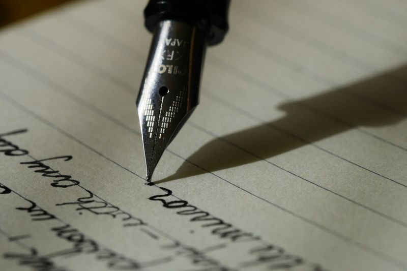 A fountain pen writing on a page